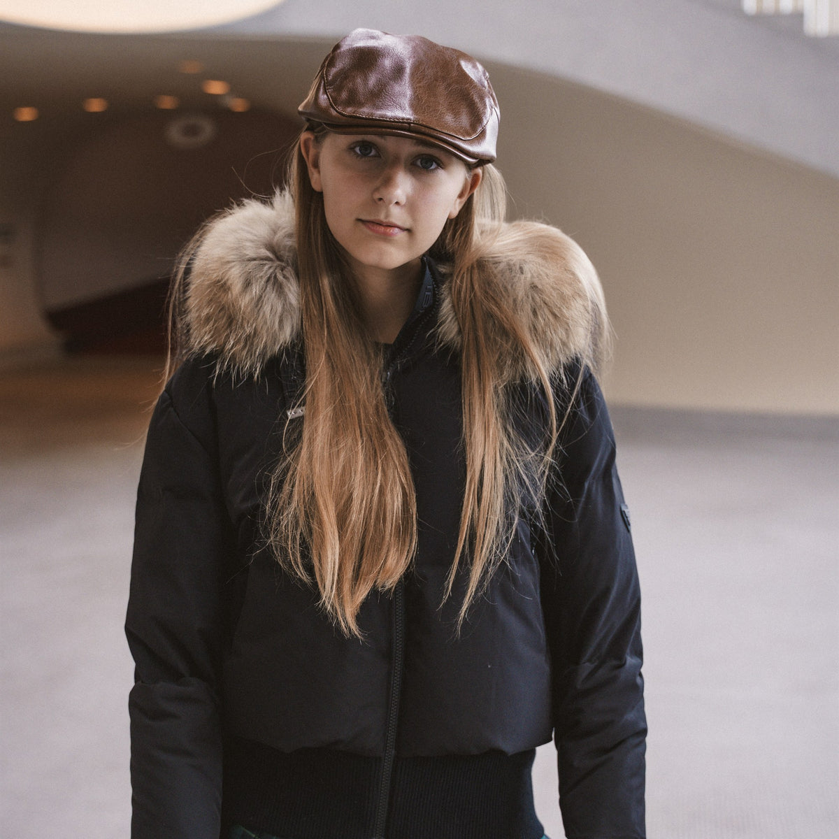 IBIS teen collection - girl in black down bomber with fur hood and leather cap