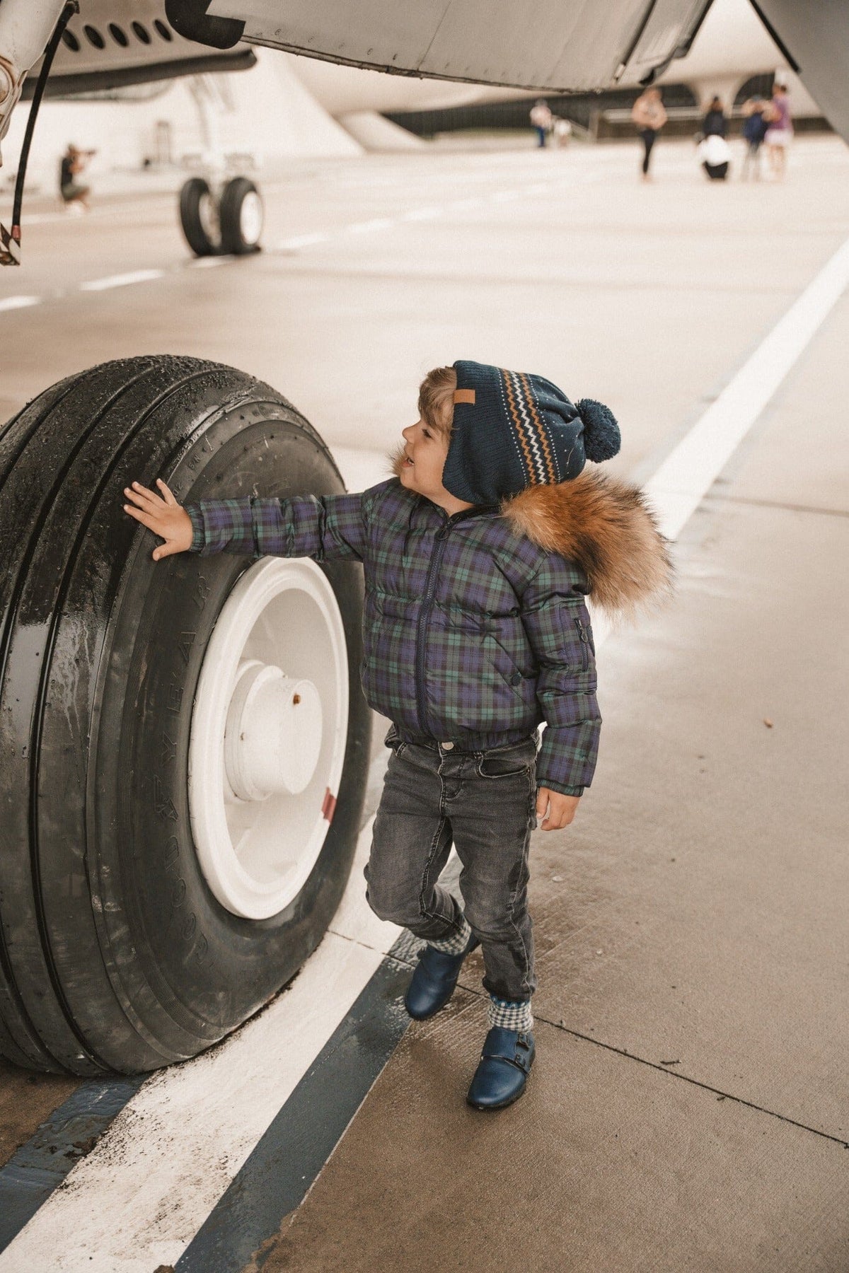 IBIS Overland boys kangaroo pocket coat in plaid - front airplane lifestyle view